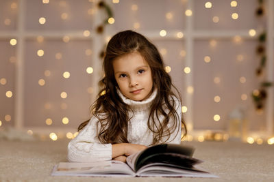 Portrait of young woman sitting at home