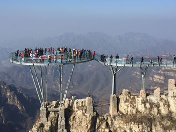 Group of people on observation point over mountains