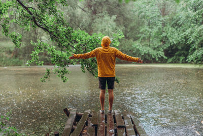 Rear view of boy standing in a lake