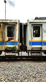 Train at railroad station platform against sky