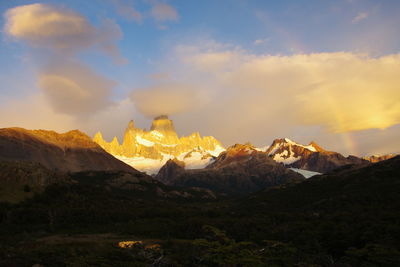 Scenic view of snowcapped mountains against sky during sunset