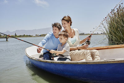 People sitting on boat against sky