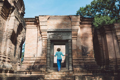 Rear view full length of woman entering temple