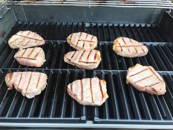 High angle view of meat on barbecue grill