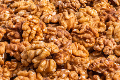 Full frame close-up background of walnuts pile without shells