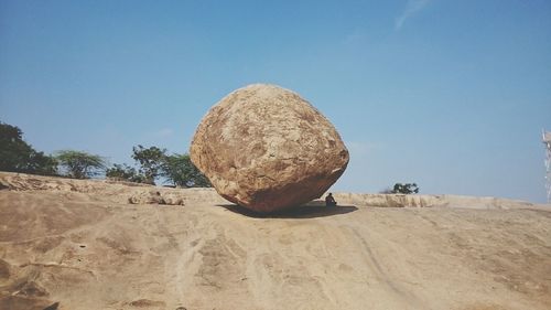 Rocks on beach against clear sky