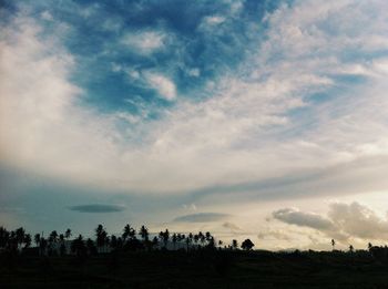 Scenic view of field against cloudy sky