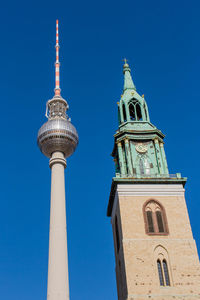 Low angle view of bell tower against blue sky