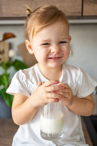 Portrait of cute baby boy eating food at home