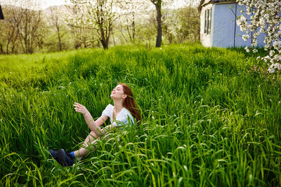 Rear view of woman standing on grassy field