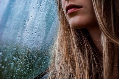 Close-up portrait of a beautiful woman in rainy day