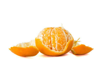 Close-up of orange fruit against white background