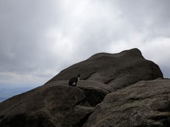 Low angle view of rock on mountain against sky