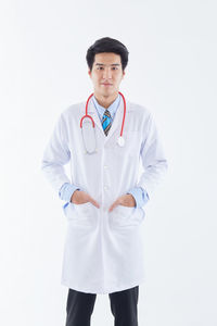 Young man standing against white background