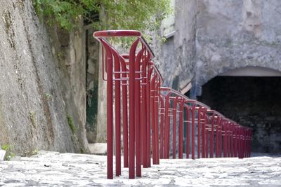 Red metallic railing on footpath