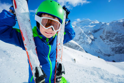 Low angle view of people skiing on snowcapped mountain