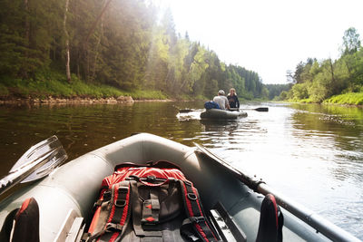 Couple traveling on inflatable boat in river during summer