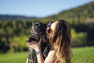 Beautiful woman with her pet french bulldog