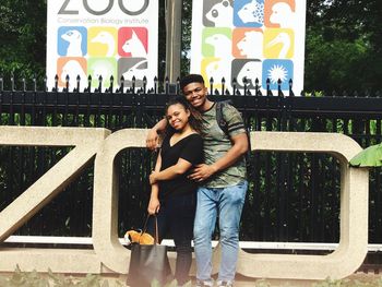 Portrait of smiling young couple standing outdoors