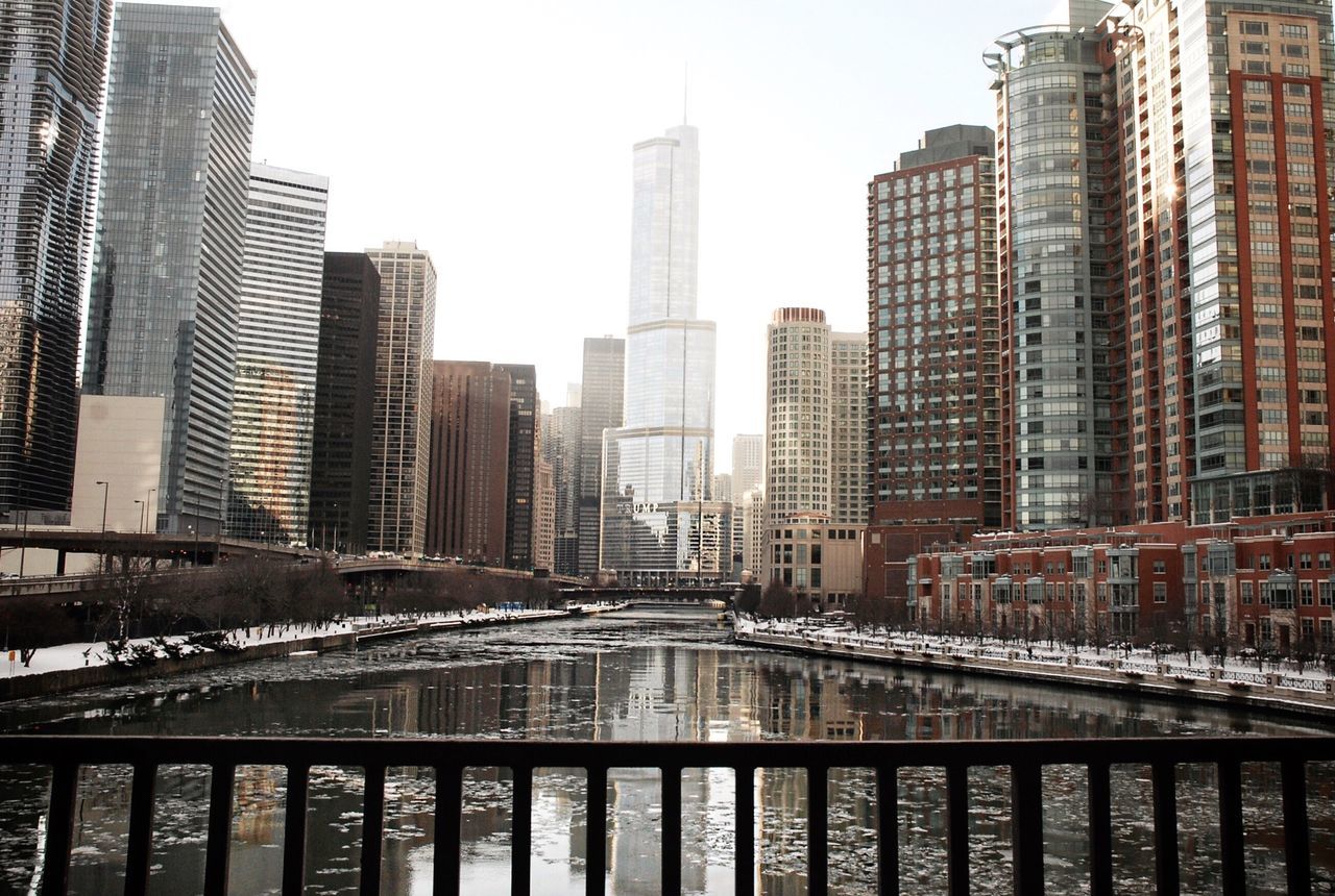 architecture, built structure, building exterior, skyscraper, city, water, modern, office building, tall - high, urban skyline, river, cityscape, clear sky, tower, financial district, waterfront, development, reflection, capital cities, city life