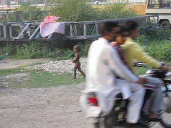 Blurred motion of children against trees in city