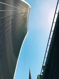 Low angle view of modern buildings against clear blue sky