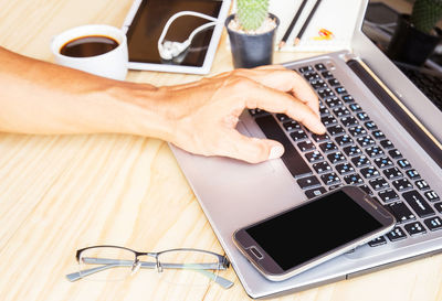 High angle view of man using laptop on table