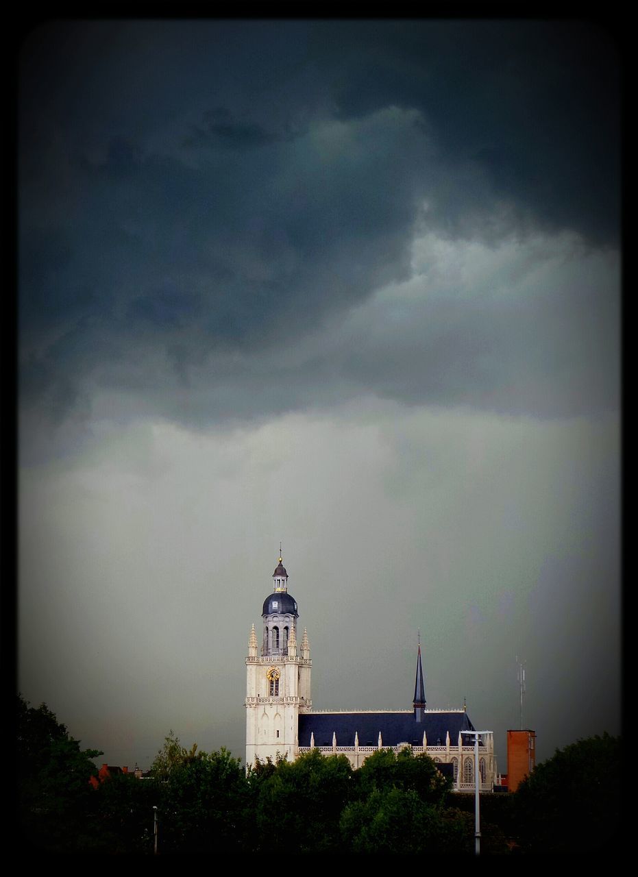 building exterior, architecture, built structure, sky, religion, transfer print, church, place of worship, cloud - sky, spirituality, auto post production filter, cloudy, low angle view, weather, high section, tree, cloud, cross