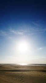 Scenic view of beach against blue sky