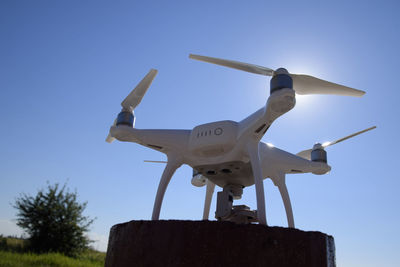 Low angle view of airplane against clear blue sky