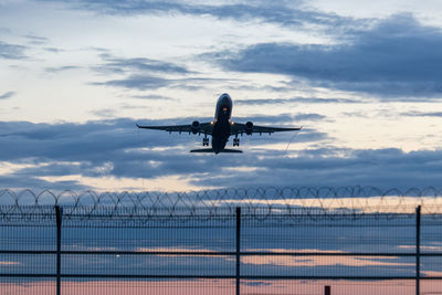 Low angle view of airplane flying in sky