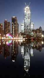 Reflection of buildings in city at night