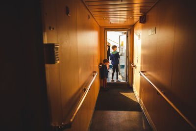 People walking in corridor of building