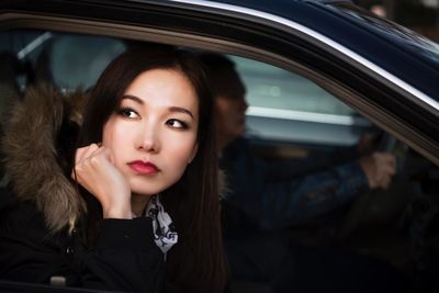 Portrait of young woman in car