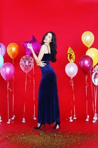 Full length of a woman with balloons