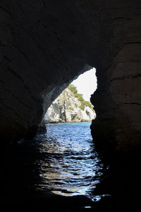 Scenic view of sea seen through cave