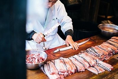 High angle view of man preparing food on cutting board