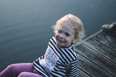 Portrait of smiling girl against water