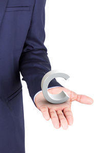 Midsection of man holding coffee cup against white background