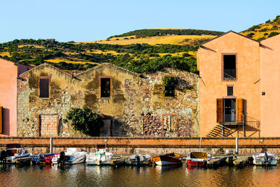 Scenic view of river by buildings against sky