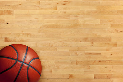 High angle view of basketball on hardwood floor