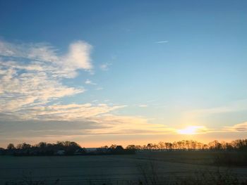 Scenic view of field against sky during sunset