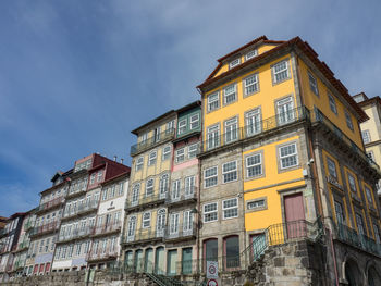 Low angle view of buildings in town against sky