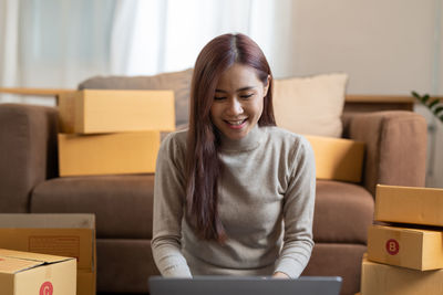 Young businesswoman using laptop while sitting at home