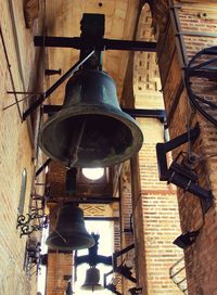 Old electric lamp hanging on table in building