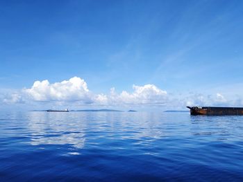 Scenic view of sea against blue sky