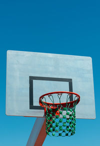 Low angle view of basketball hoop against clear blue sky