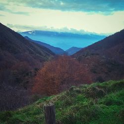 Scenic view of mountains against cloudy sky