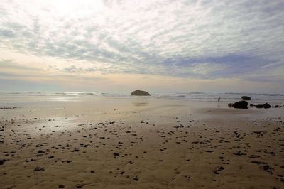 Scenic view of beach against sky during sunset