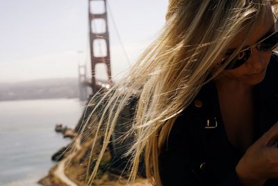 Close-up portrait of woman against sky